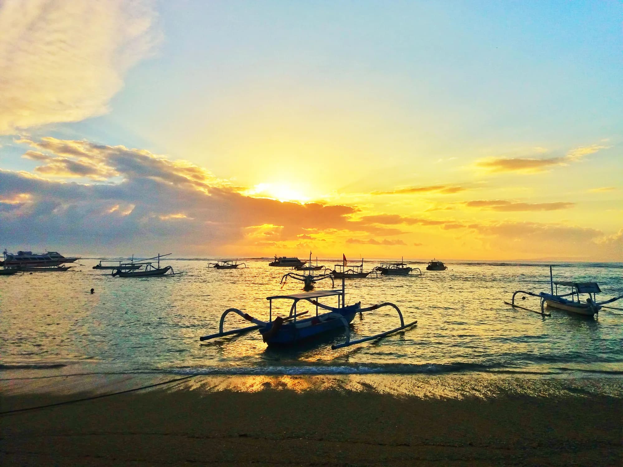 Traditional jukung boats at sunrise on Sanur Beach, Bali
